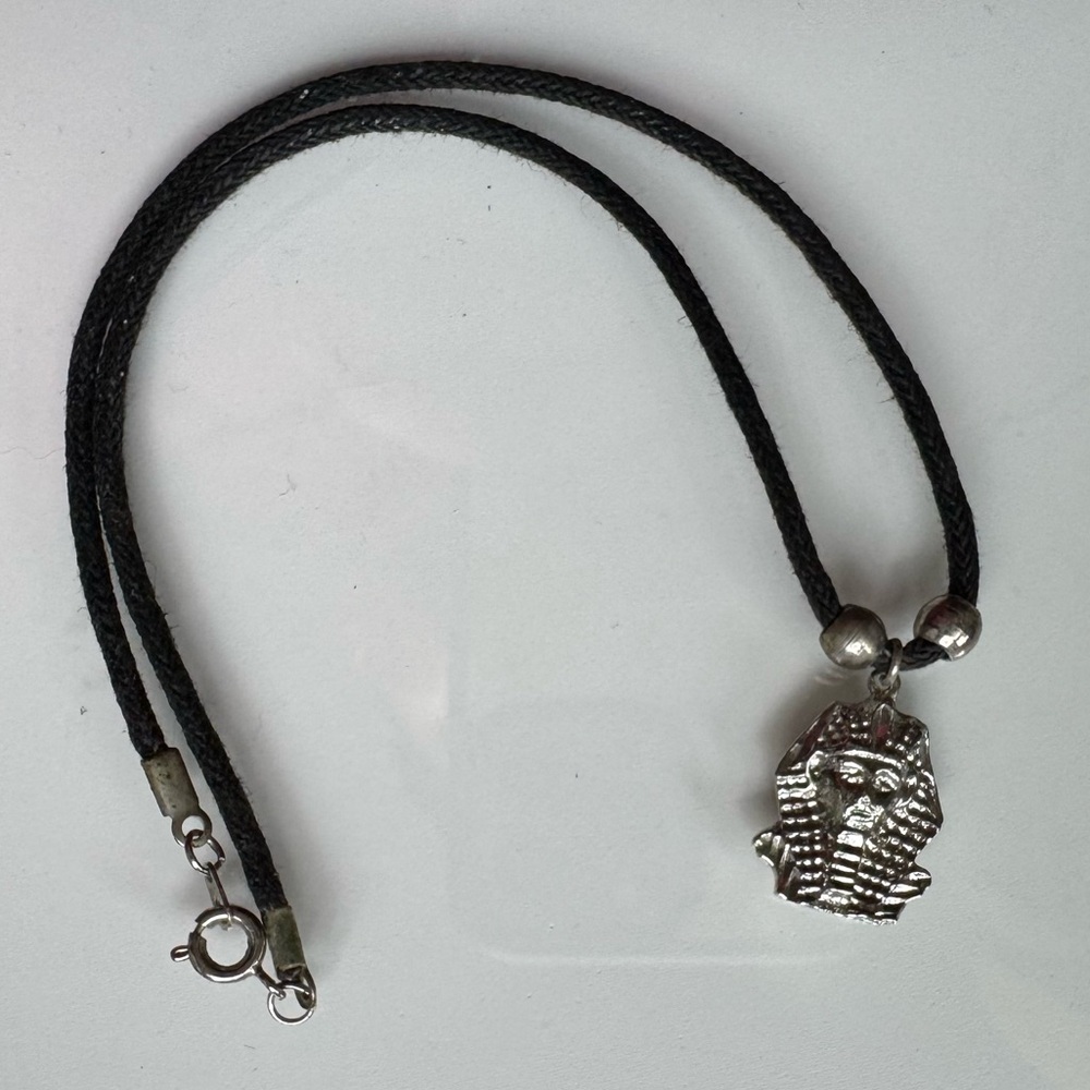 Silver Egyptian pharaoh pendant on black cord